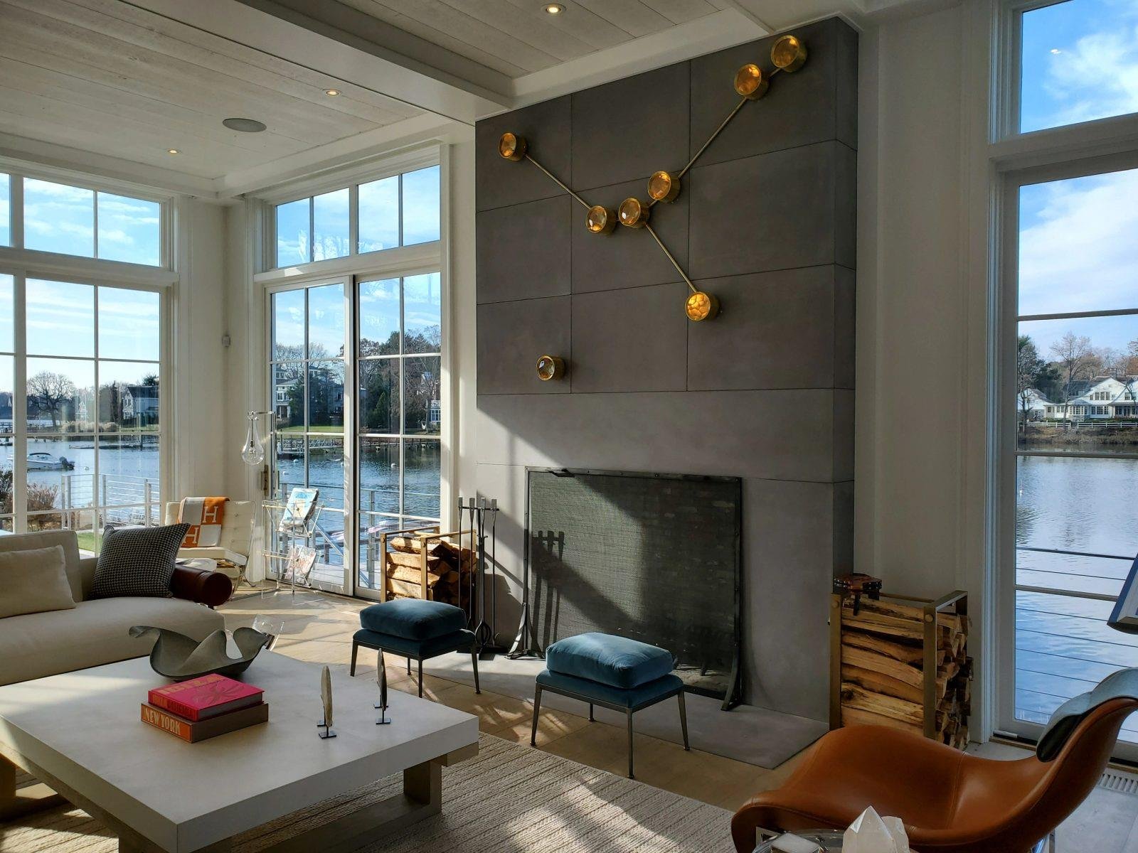 Tall concrete fireplace surround with waterfront view, crafted by Concrete Encounter